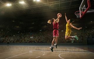 A young woman playing basketball.